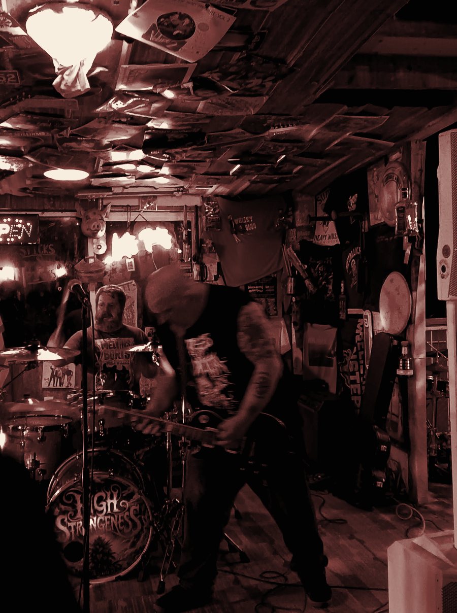 Justin on guitar with the High Strangeness kick drum behind him at Flying Z Farms